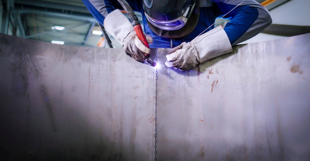 Welder working in factory