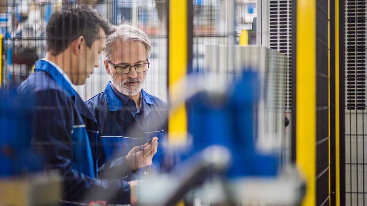 Factory engineer standing together and discussing